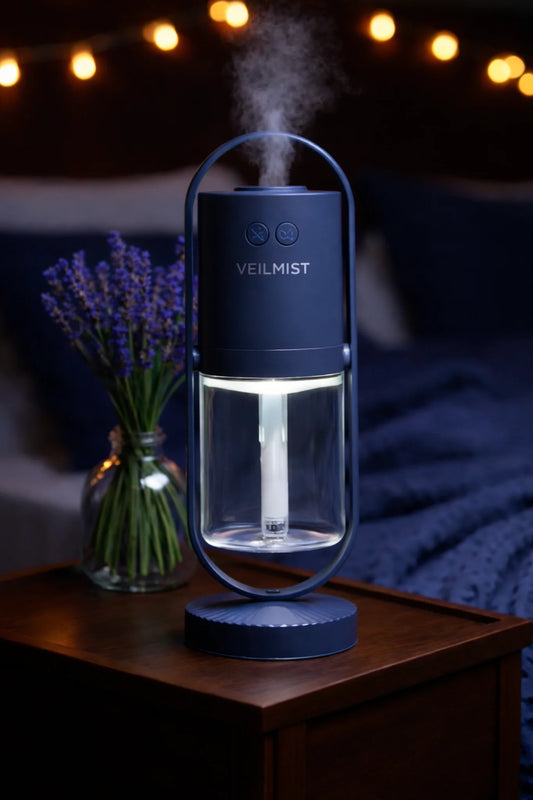 Lumaveil Veilmist ambient humidifier with soft mist lighting in midnight blue for bedroom atmosphere